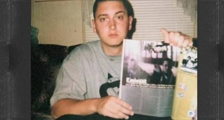 レコードを手にしてカメラを見るEminem。